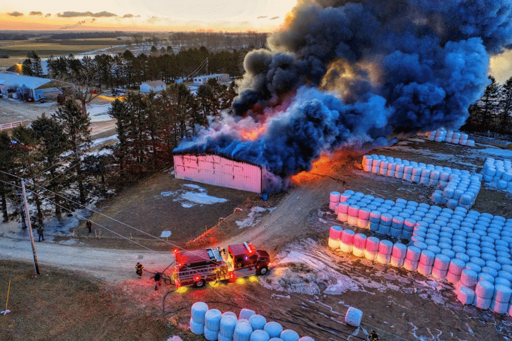 Flames and smoke rising from a warehouse fire