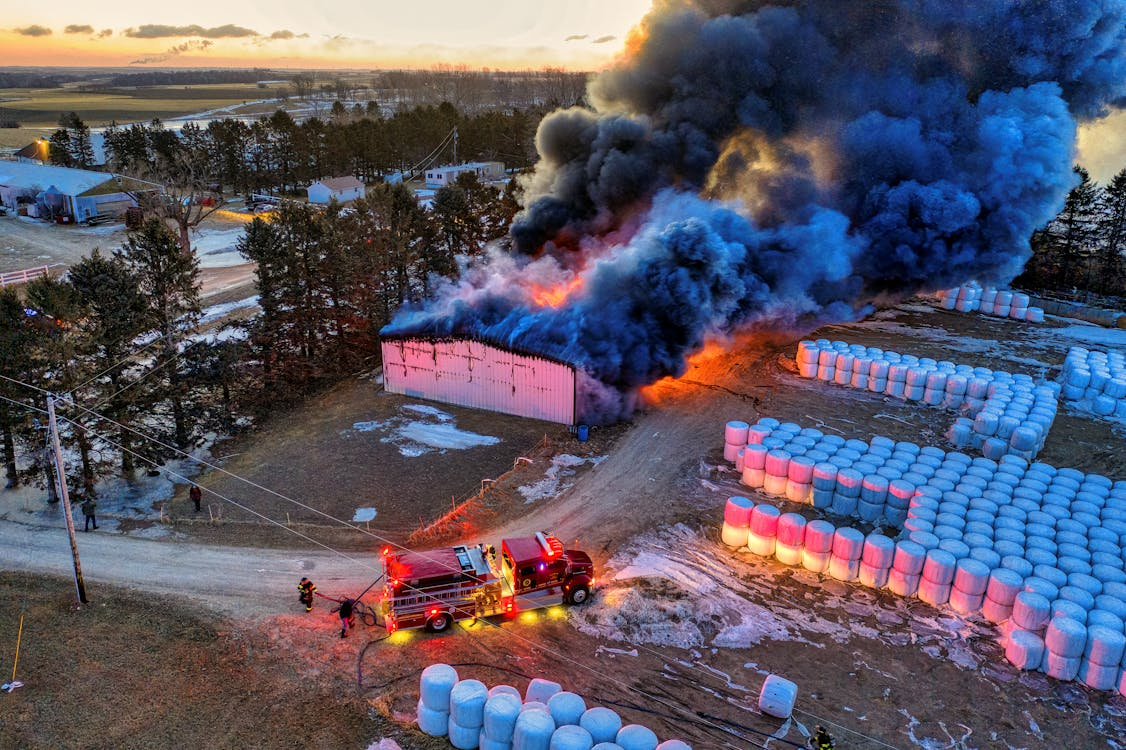 Flames and smoke rising from a warehouse fire