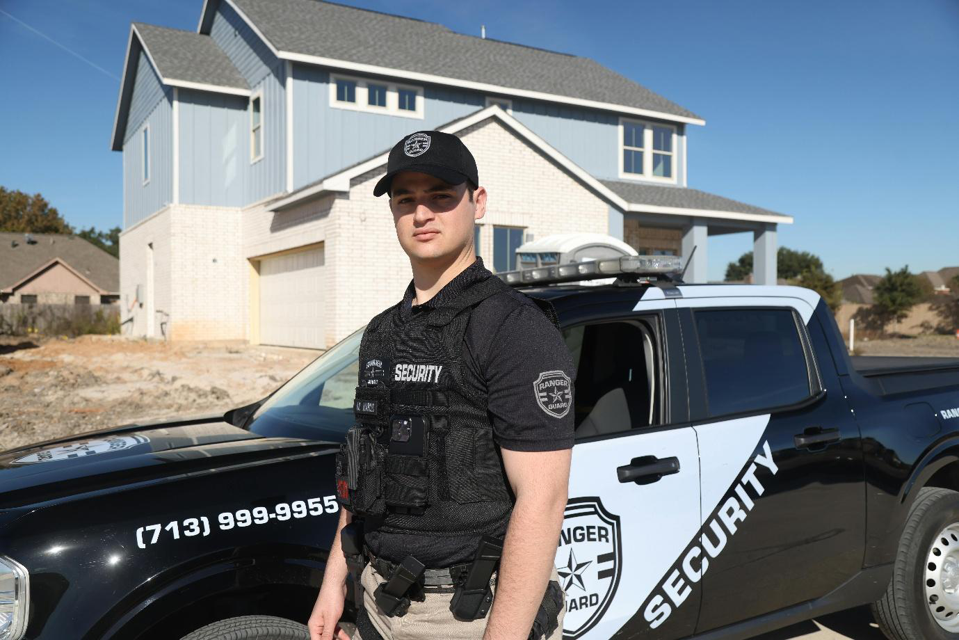 a security officer standing by his vehicle at the house
